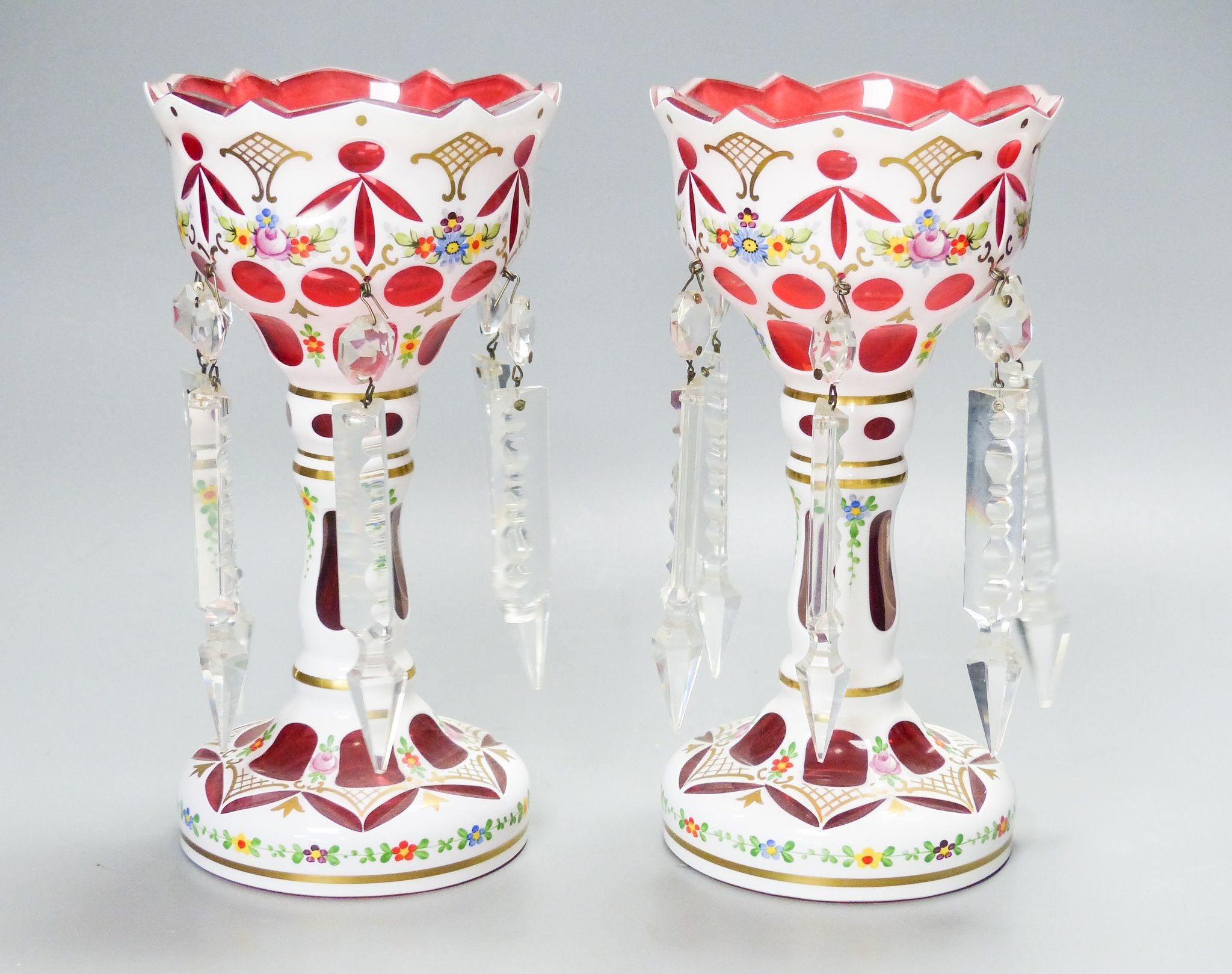 A pair of Bohemian style white and ruby overlaid glass table lustres, 20th century, 20.5 cm high